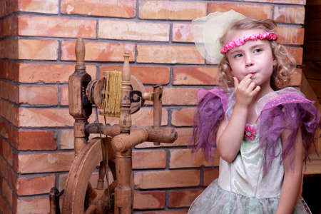 Adorable little girl playing in the story of the sleeping princessの写真素材