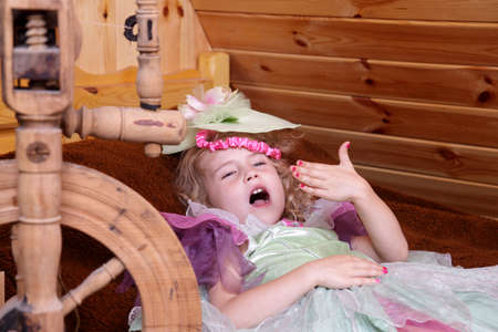 Adorable little girl playing in the story of the sleeping princessの写真素材