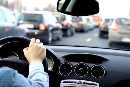 The driver waits in a big traffic jam in the car