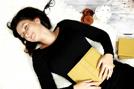 cheerful girl sleeping with a book