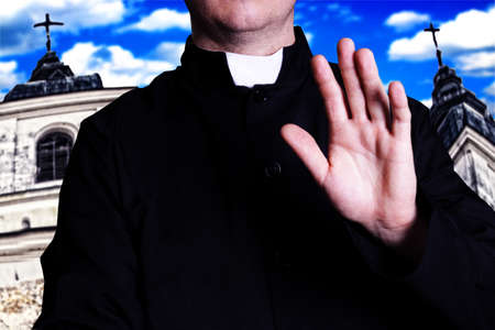 The priest in front of churchの写真素材