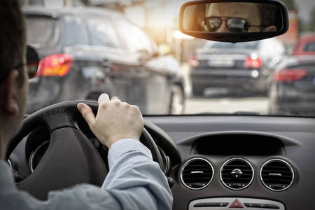 Man in sunglasses drive a car