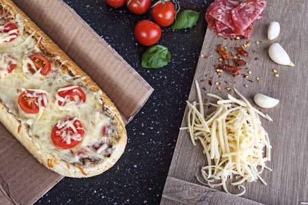 delicious casserole from the oven with tomatoes salami and cheese