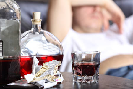 Lazy day - man lying on the bedの写真素材