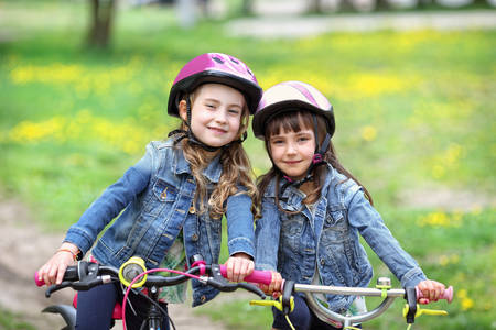 Two young friends on bicyclesの写真素材