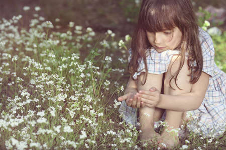 Young girl on the floral meadowの写真素材
