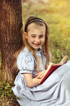 delighted young girl reading a book