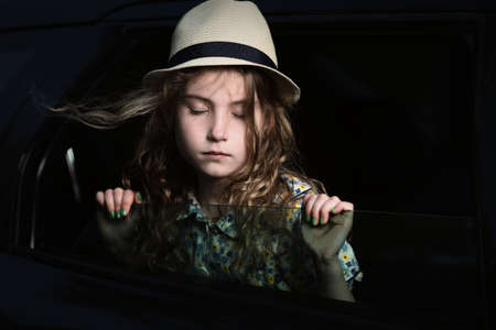 Pensive and laid-back girl in a car