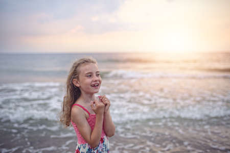 Young cheerful girl laughs on the beachの写真素材