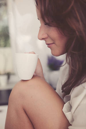 Woman with an aromatic coffeeの写真素材