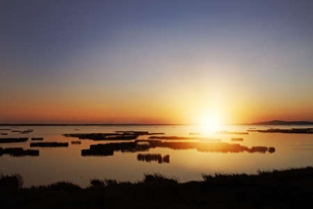 Sunrise over the lakeの写真素材