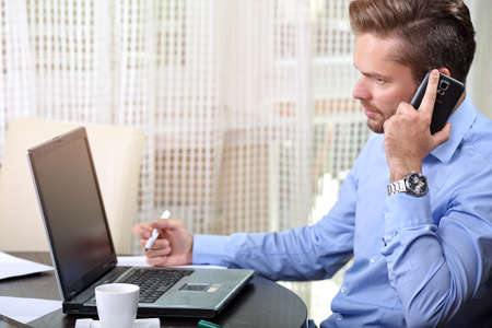 businessman talking on the phone at home
