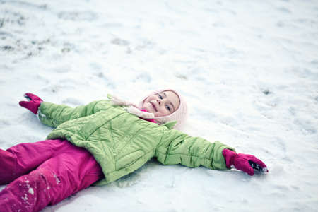 Youthful girl playng outside in snowの写真素材