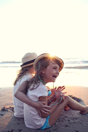 Young friends laughing on the beachの写真素材