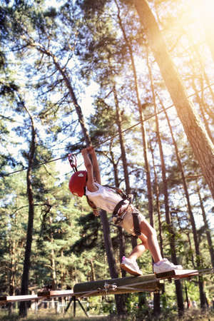 Adventure ropes course - a young girl on a rope