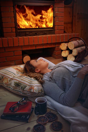 Moment to chillout with tea at home with fireplaceの写真素材