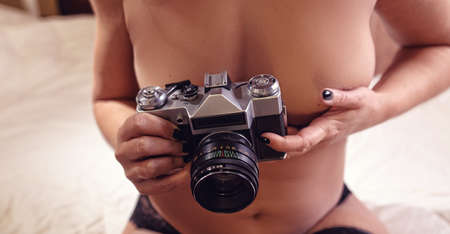 Sexy girl lying naked on bedの写真素材