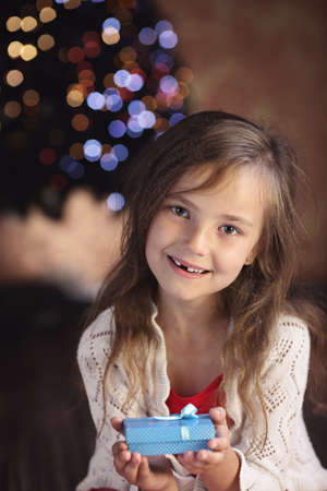 Young girl with a Christmas presentの写真素材