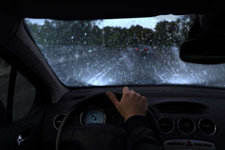 Driving car in very snowy nightの写真素材