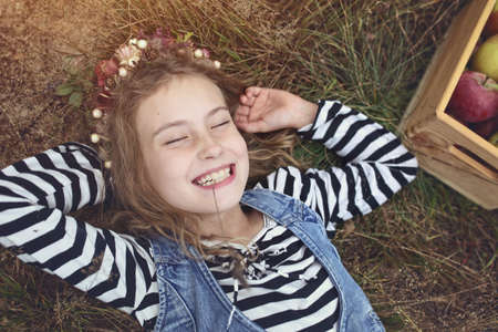 amused lovely young girl laughs on the grass