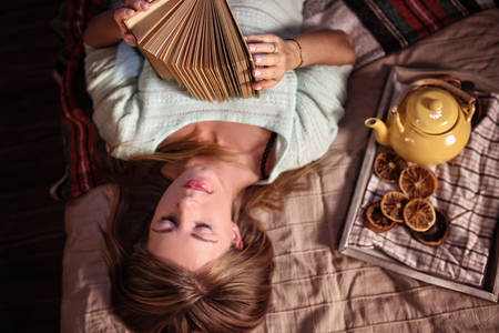 moment of reflection with bookの写真素材