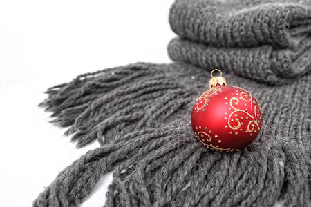 Scarf and red bauble on a white backgroundの写真素材