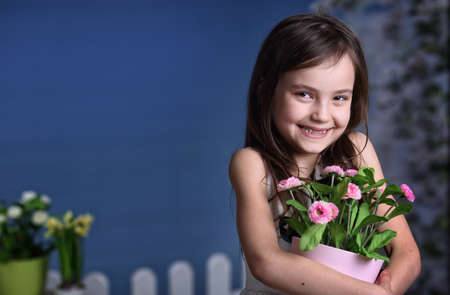 Joyful girl with a bouquet of spring flowersの写真素材