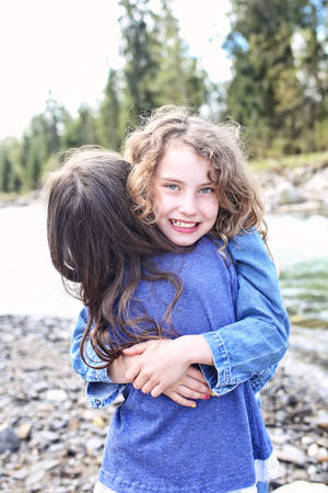 Two young girls have fun outsideの写真素材