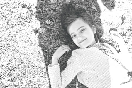 Smiling girl lies in the flowersの写真素材