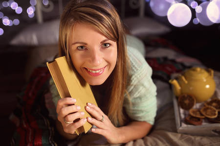 Happy woman with a bookの写真素材