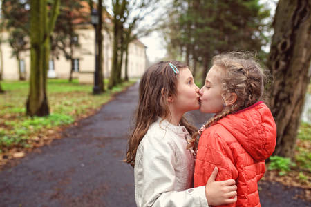 Young friends in the colorful autumn day have funの写真素材