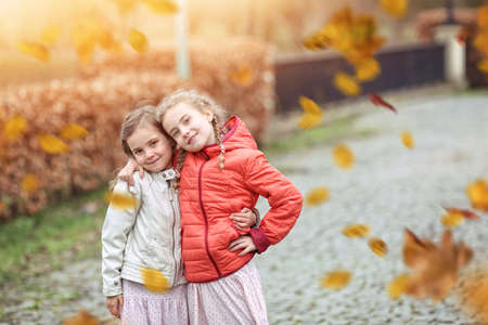 Young friends in the colorful autumn day have funの写真素材