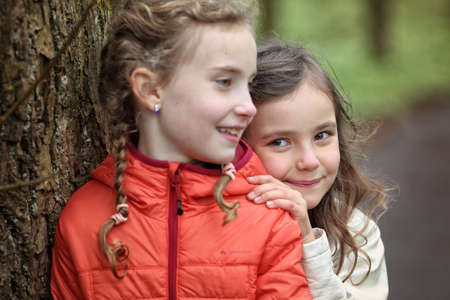Young friends in the colorful autumn day have funの写真素材