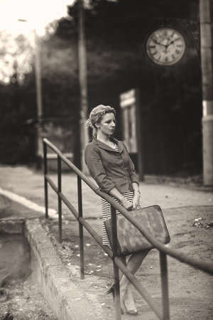 Pensive woman on railway stationの写真素材