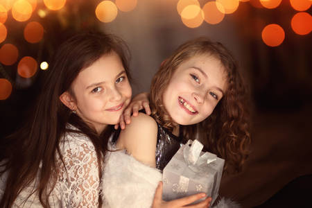 Young sisters have fun on Christmas Dayの写真素材