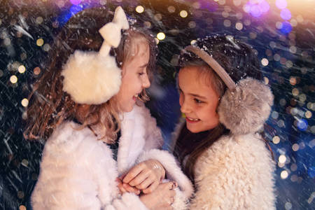 snow girls have fun outsideの写真素材