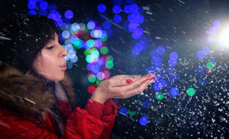 young girl is blowing snow の写真素材