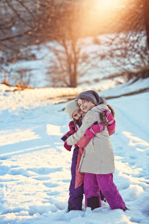 Young friends on a walk on a winter sunny dayの写真素材