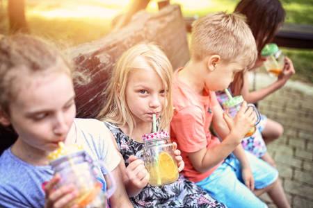 kids drink lemonade on a sunny dayの写真素材