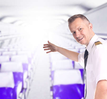 Smiling captain invites you to the plane