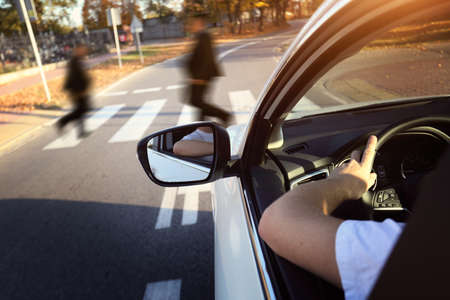 driver lets the pedestrians on the aisleの写真素材
