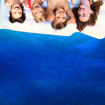 young children have joy in the pool on a hot summer dayの写真素材