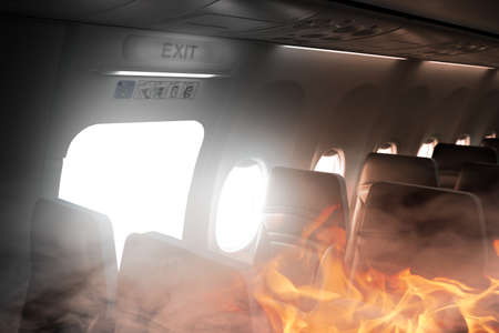 fire on the plane and an evacuation exit openedの写真素材