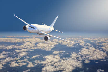 passenger plane is flying high above the clouds
