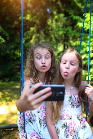 silly faces in front of the phone - friends make selfie