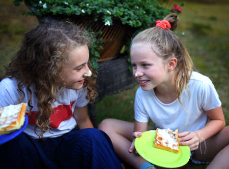 Fun and laughter of young friends while eating sweetsの写真素材