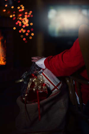 santa claus is watching TV in the cottageの写真素材