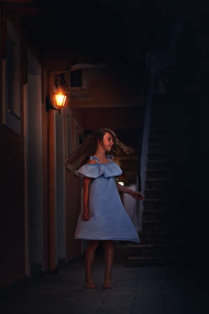 young girl is dancing in the moody lightの写真素材
