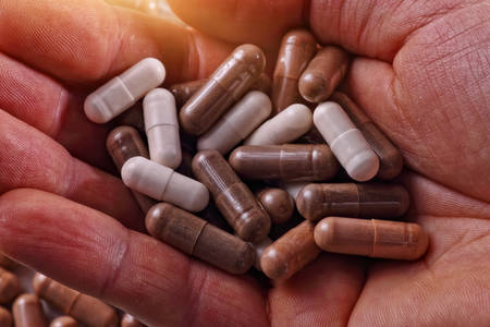 tablets and medications on handの写真素材