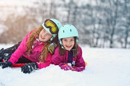 teen friends laugh on a winter day on the ski slopeの写真素材